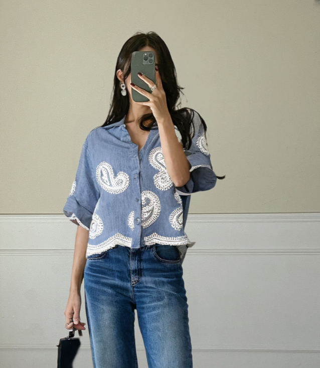 Women's button-up shirt showcases a relaxed fit